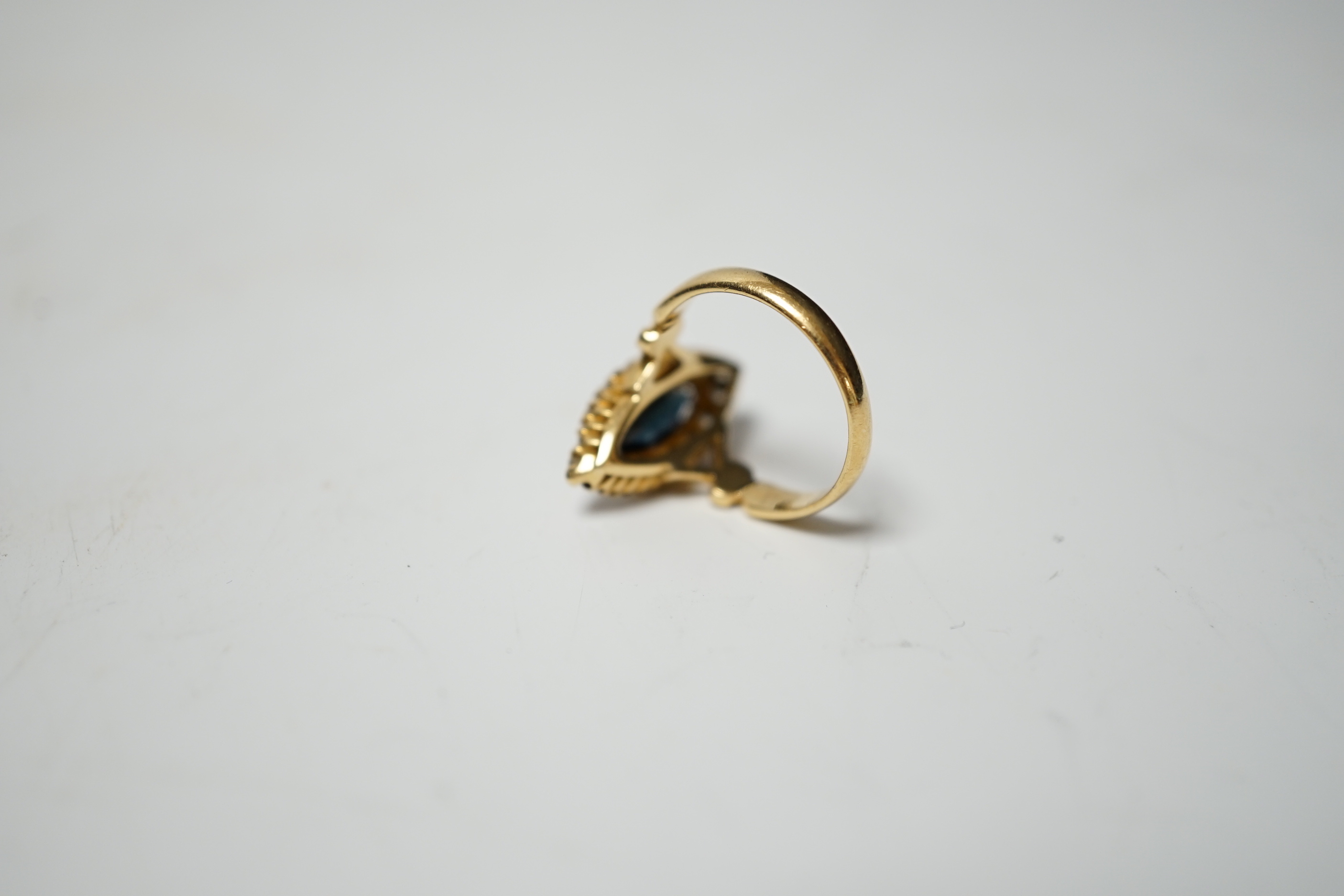 An Edwardian 18ct gold, sapphire and diamond cluster set marquise shaped ring, size K, gross weight 4.2 grams.